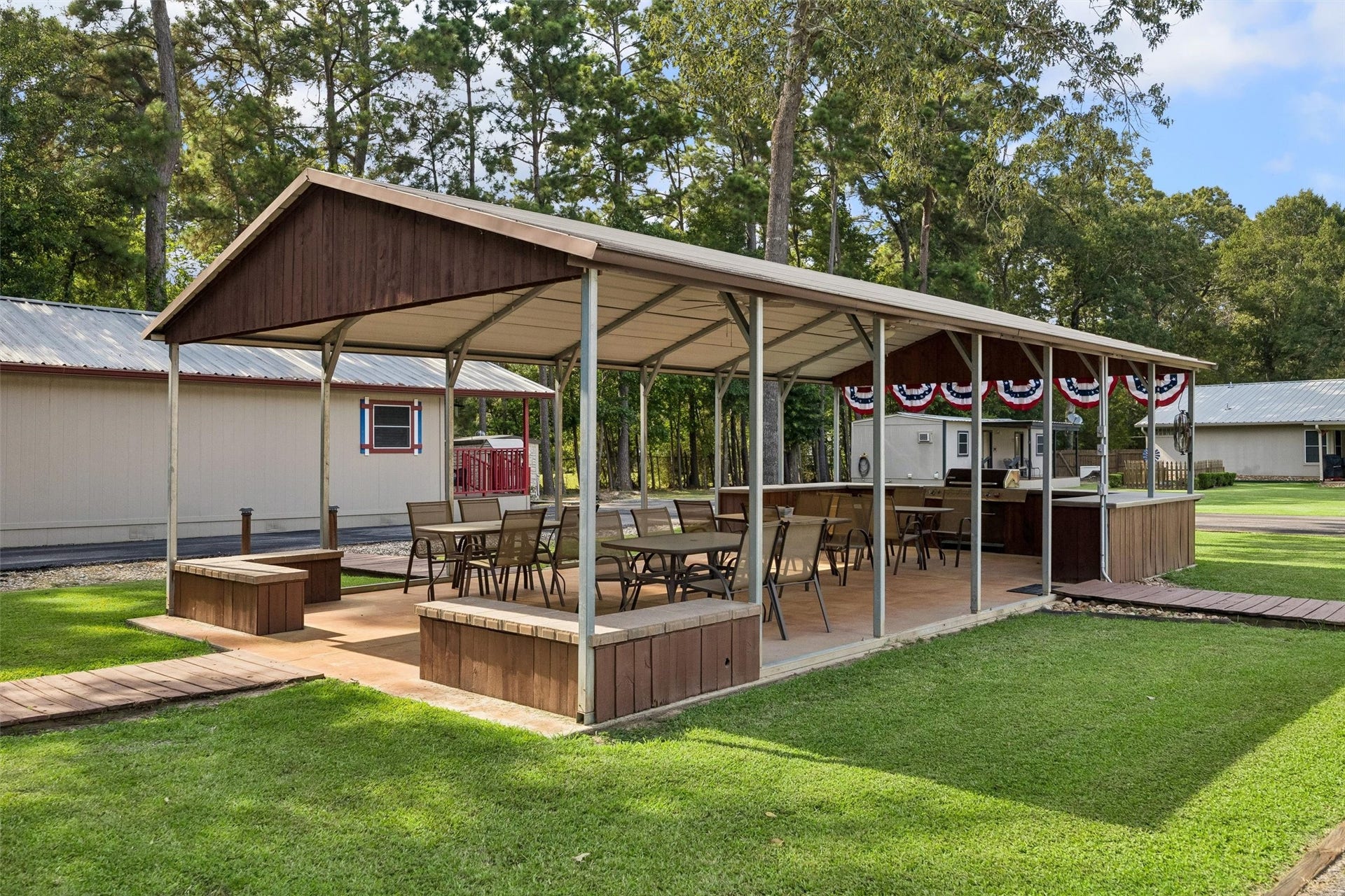 Outdoor covered pavilion complete with grill, table and chairs