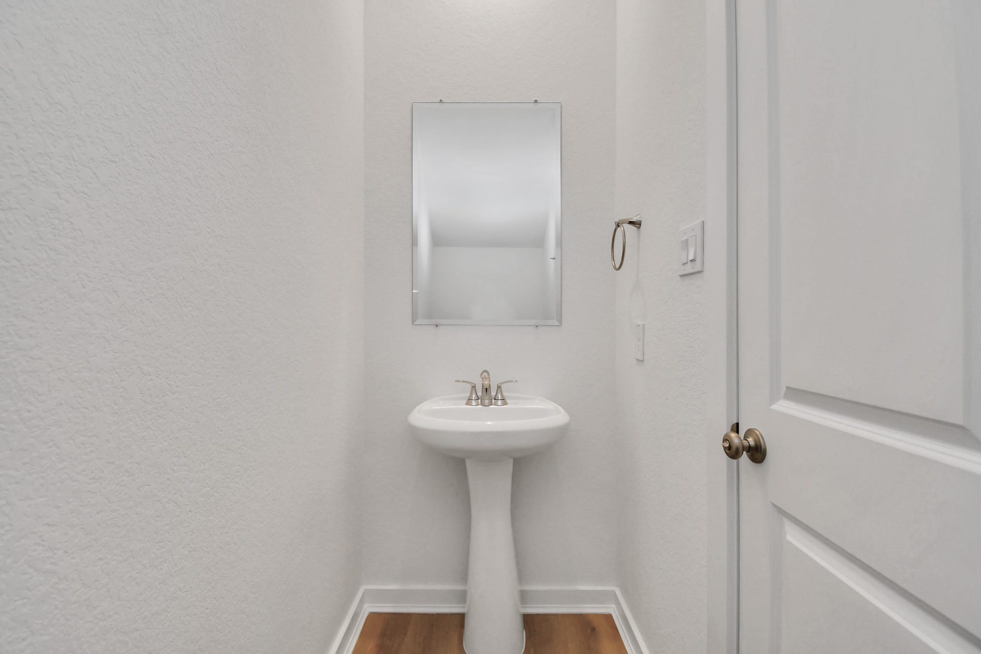 16506 Texas Hill Country Rd, Cypress, TX 77433 This crisp, white powder room offers a clean and simple design, creating a fresh and inviting space.