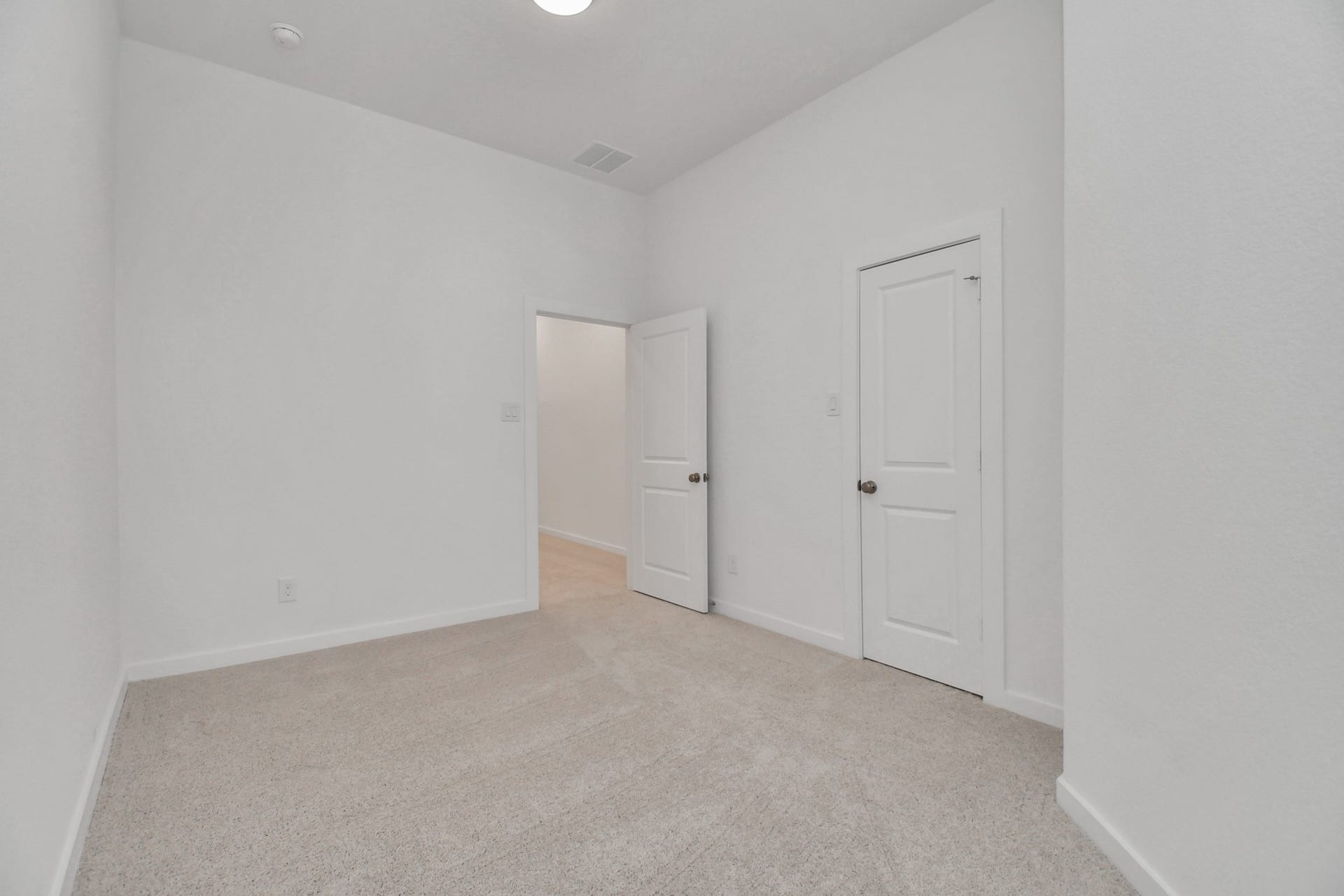 16506 Texas Hill Country Rd, Cypress, TX 77433 The secondary bedroom is bright and airy with a white color scheme and plush carpet, offering a comfortable and inviting space.