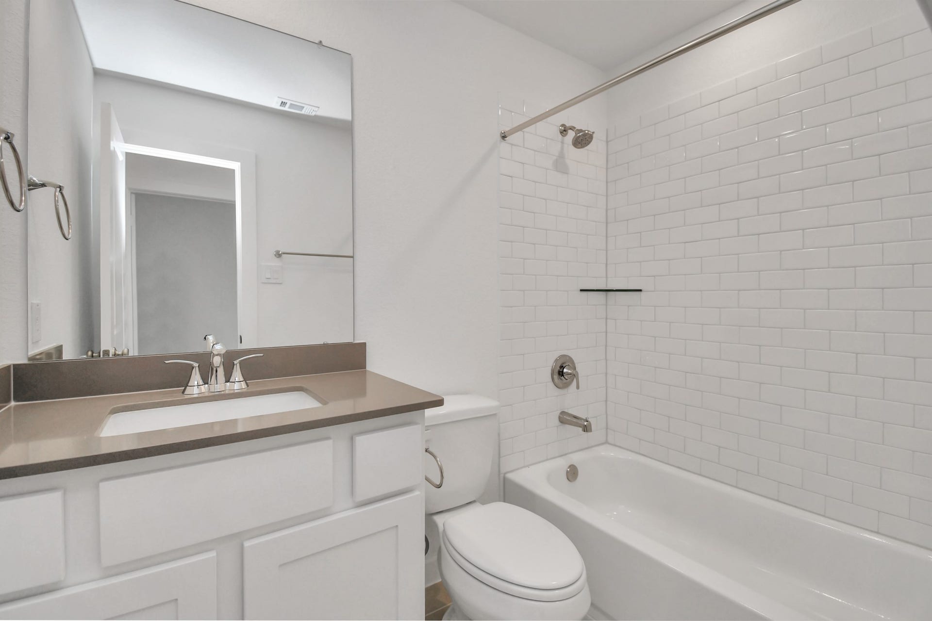 16506 Texas Hill Country Rd, Cypress, TX 77433 The hall bathroom features a clean white design and includes a convenient tub-shower combo for versatile bathing options.
