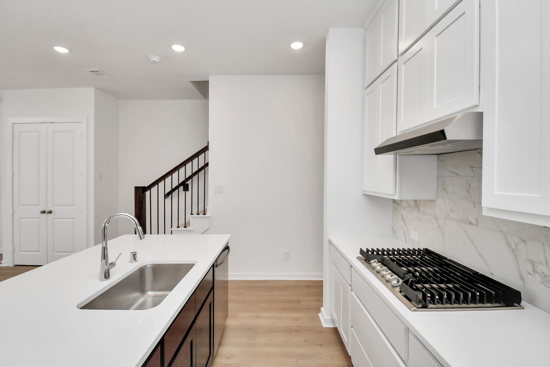 16506 Texas Hill Country Rd, Cypress, TX 77433 The kitchen offers a closer look at its stylish design, featuring a gas cooktop, ample cabinetry, and stainless steel appliances, blending functionality with modern elegance.