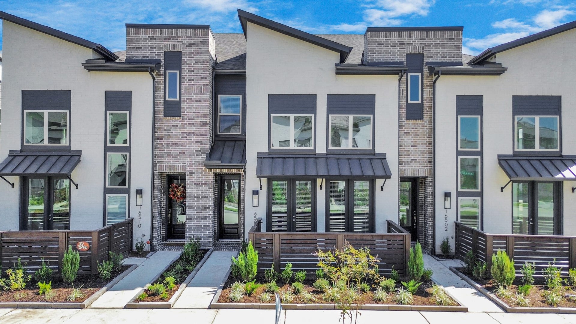 16506 Texas Hill Country Rd, Cypress, TX 77433 This modern townhome features sleek architecture, large windows, and a stylish entryway, blending elegance with contemporary design.