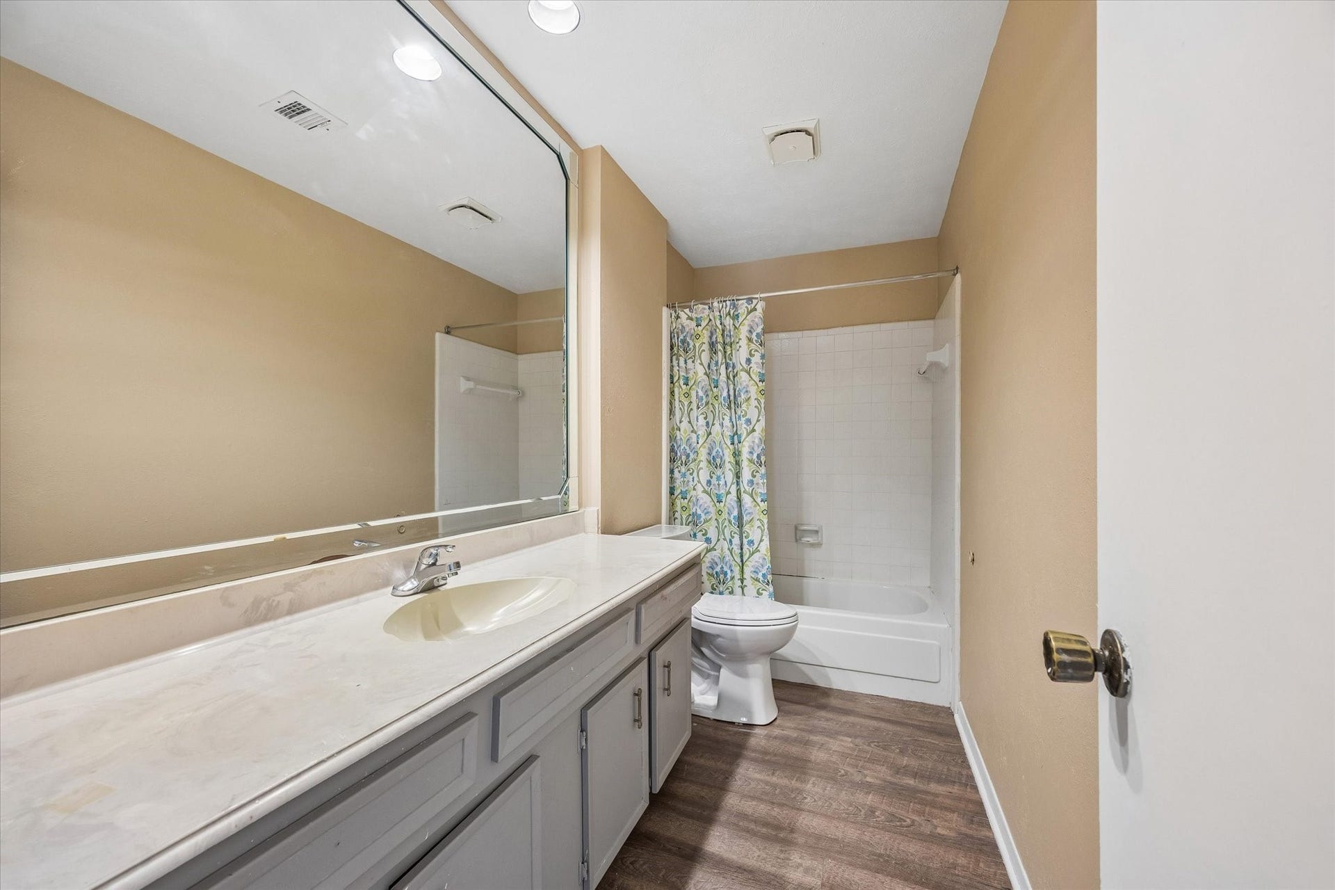 10110 Sagemill Drive, Houston, TX 77089 Spacious bathroom featuring a large mirror, elegant vanity, and a classic shower-tub combination.