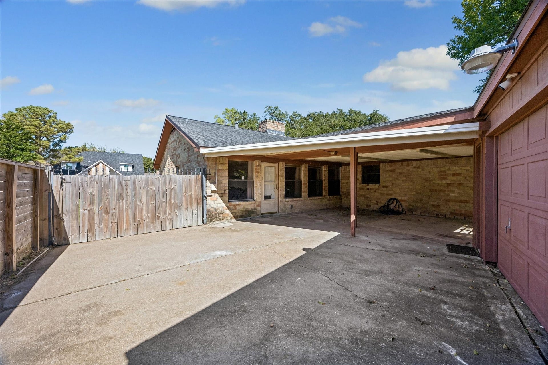 10110 Sagemill Drive, Houston, TX 77089 Spacious backyard with a covered patio, perfect for outdoor gatherings and ample parking space.
