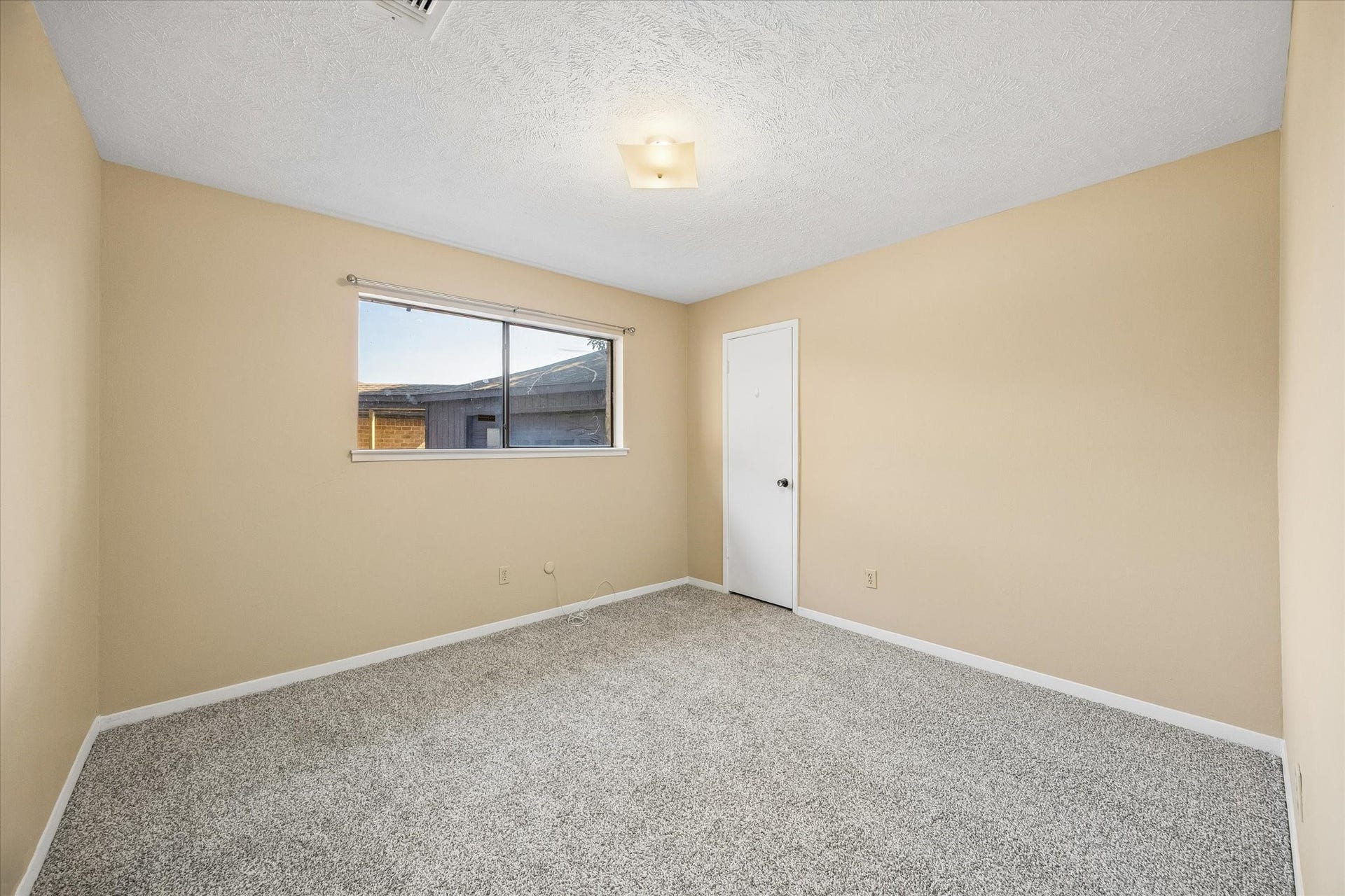 10110 Sagemill Drive, Houston, TX 77089 Spacious bedroom with neutral walls, plush carpeting, and a large window for natural light.