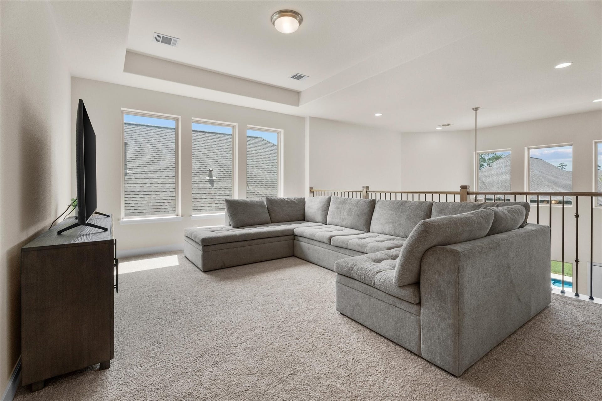 A spacious game room offers endless possibilities for movie nights, play space, or a second living area.
