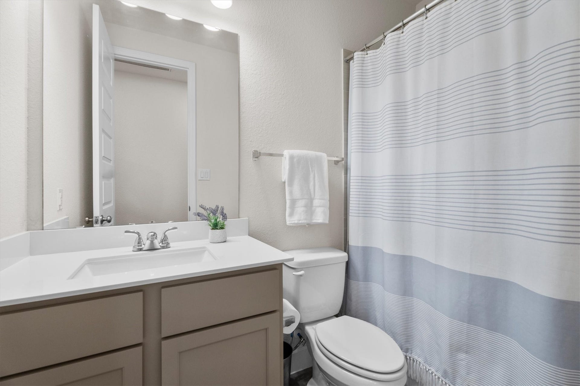 Additional full bath downstairs offers comfort and convenience for busy households.