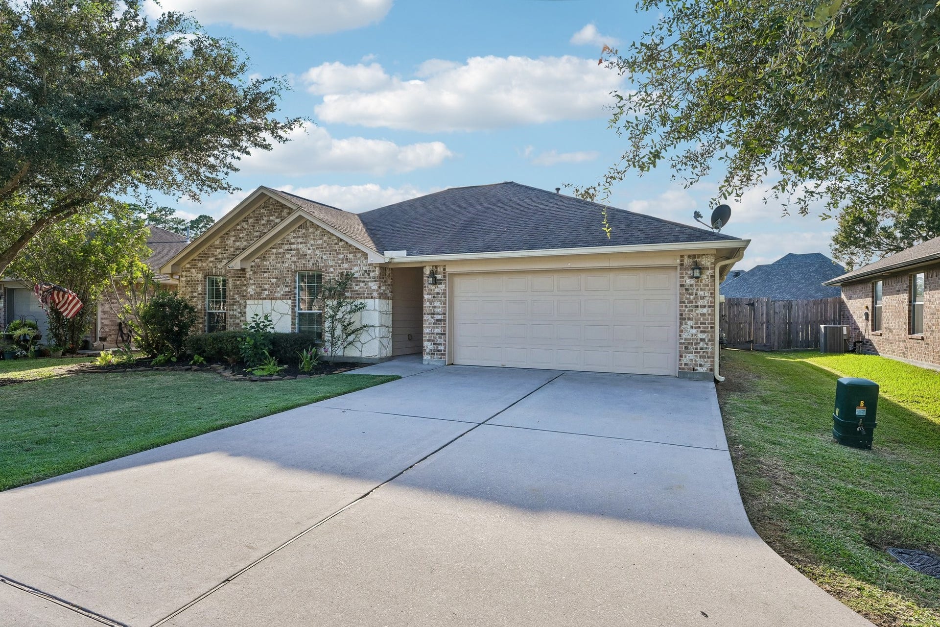 5012 Bayou Dr, Dickinson, TX 77539 Charming single-story home with a brick exterior, manicured front yard, and a spacious two-car garage, nestled in a peaceful neighborhood.