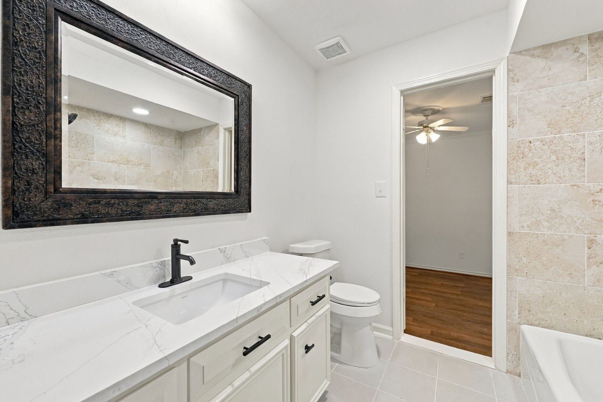 1430 Stependale Drive, Katy, TX 77450 Contemporary bathroom with dual vessel sinks, a teal vanity, elegant mirrors, and a spacious walk-in shower.