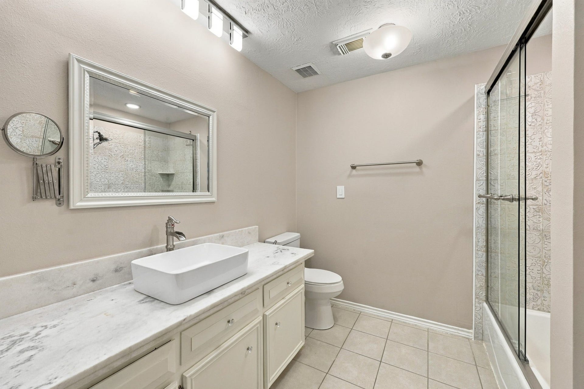 1430 Stependale Drive, Katy, TX 77450 Contemporary bathroom with dual vessel sinks, a teal vanity, elegant mirrors, and a spacious walk-in shower.