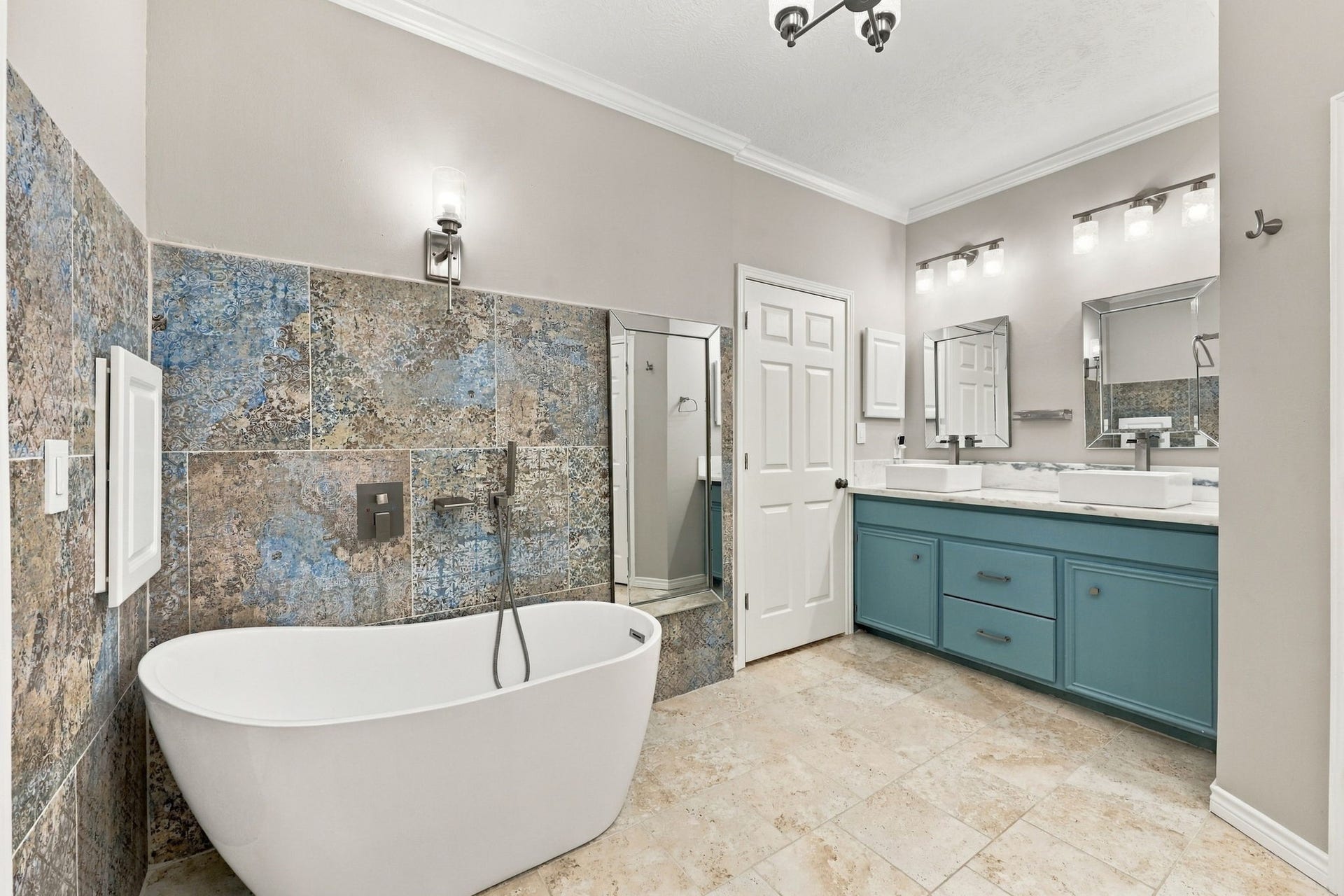 1430 Stependale Drive, Katy, TX 77450 Primary bathroom featuring a freestanding soaking tub, decorative tile accents, and a separate glass-enclosed shower.