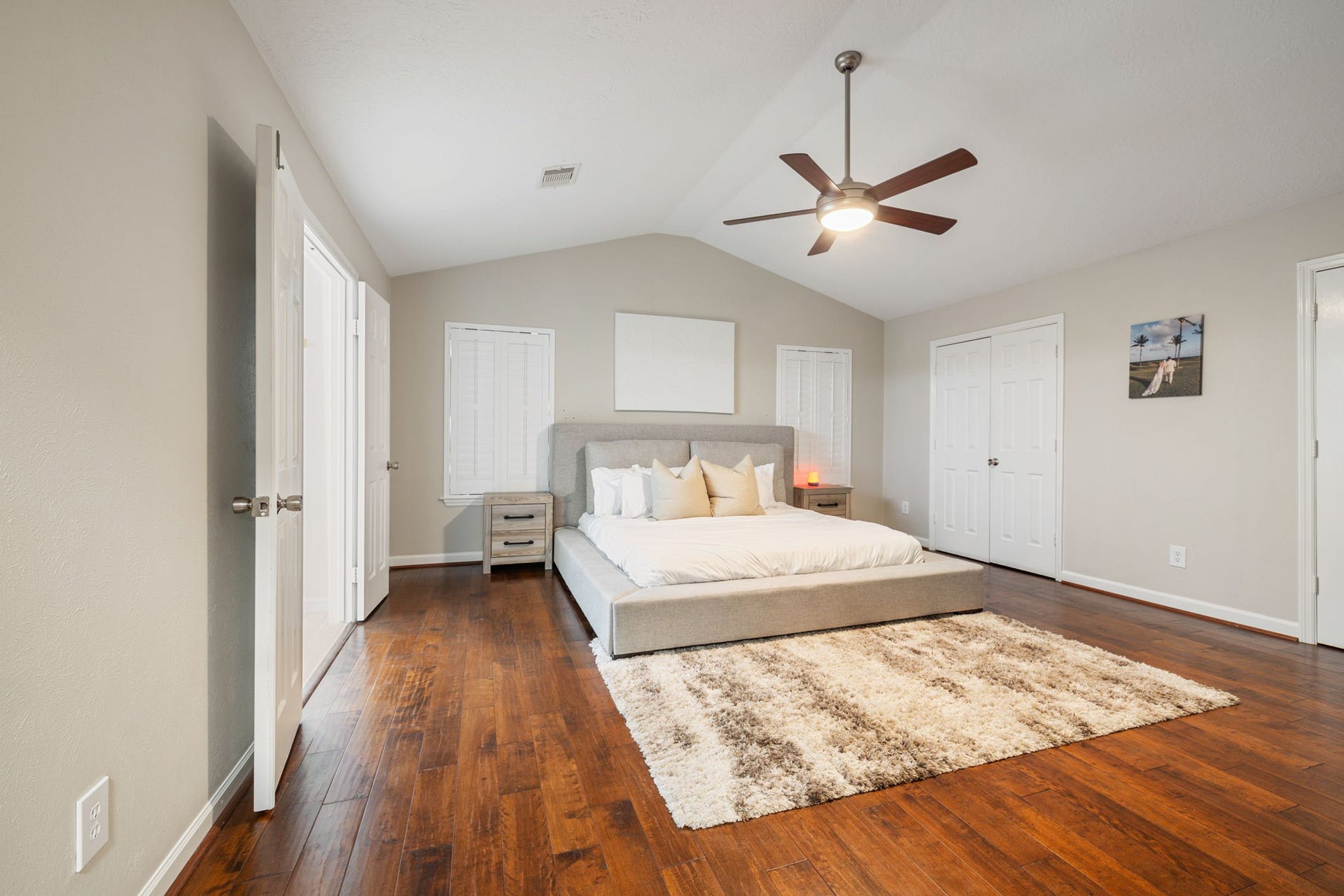 236 Sunset Ridge Drive, League City, TX 77573 Generously sized primary suite featuring rich hardwood flooring, a vaulted ceiling, and two separate closets.