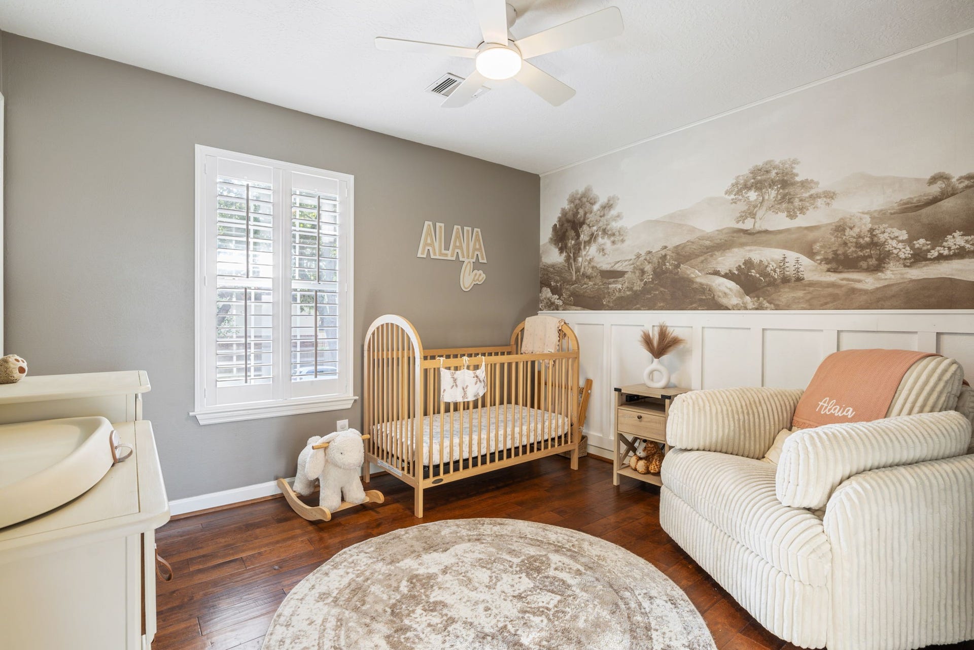 236 Sunset Ridge Drive, League City, TX 77573 Charming secondary bedroom with hardwood flooring, plantation shutters, and decorative wall detailing.