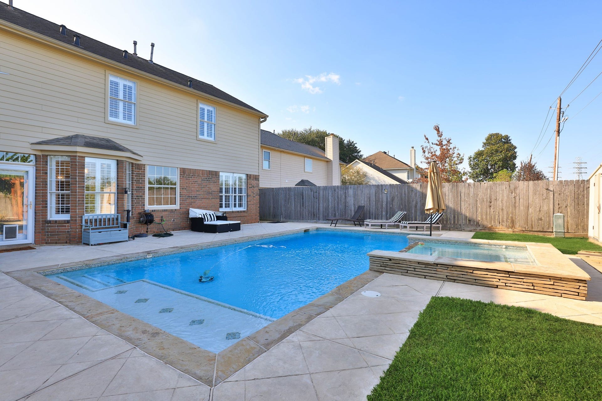 236 Sunset Ridge Drive, League City, TX 77573 Your private backyard retreat awaits, complete with a sparkling swimming pool, hot tub, and expansive surrounding patio.