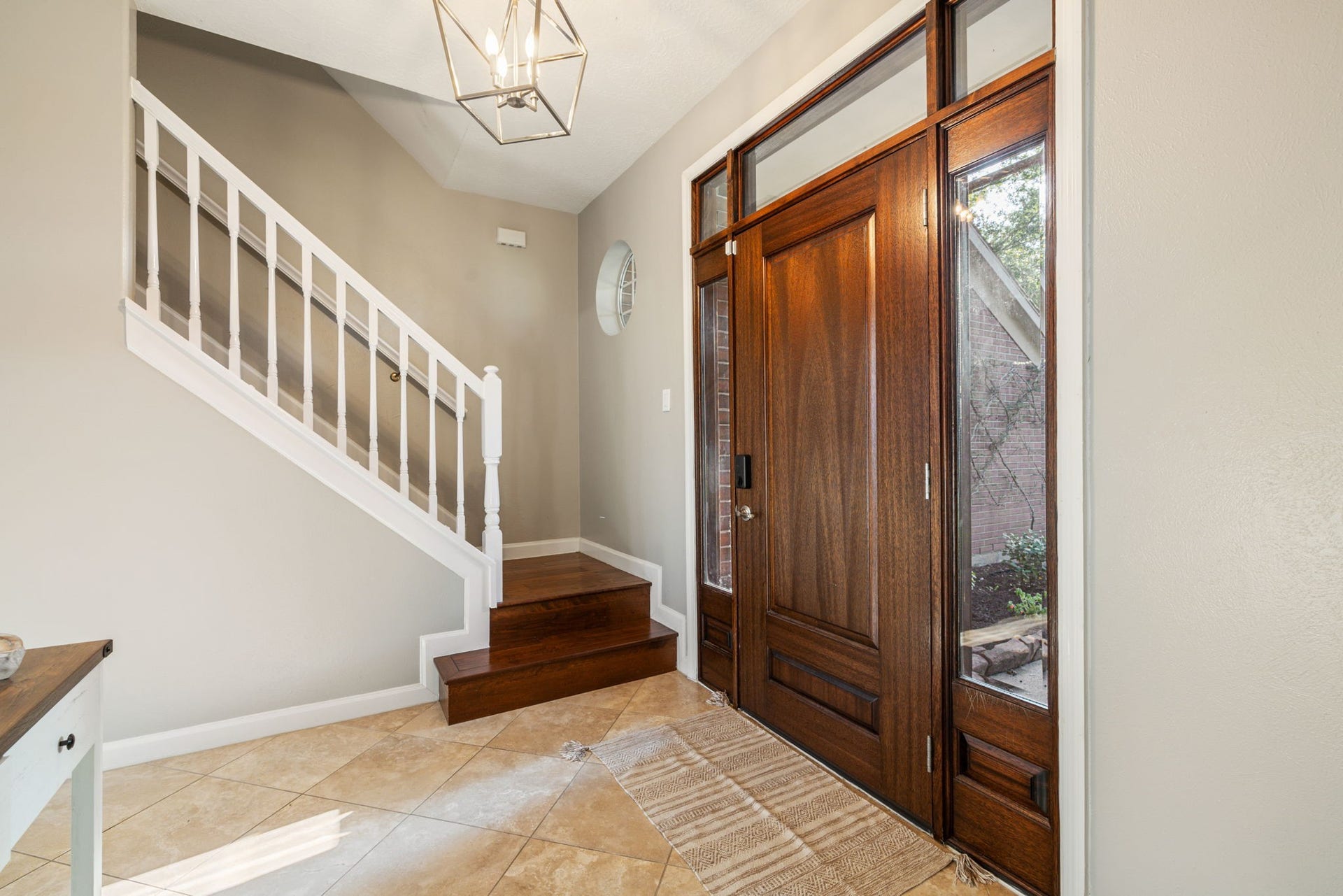 236 Sunset Ridge Drive, League City, TX 77573 A handsome wood entry door, classic staircase, and contemporary lighting create an elegant introduction to the home.