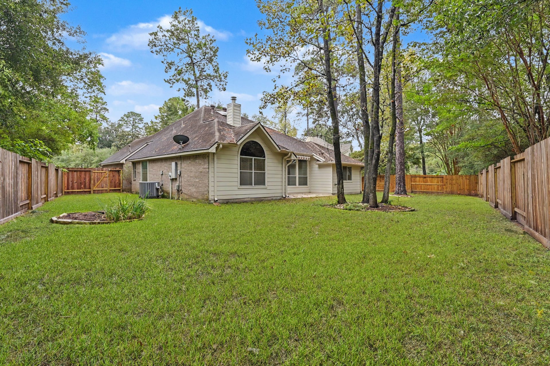 26 N Brooksedge Circle, The Woodlands, TX 77382 View of the backyard with mature trees.