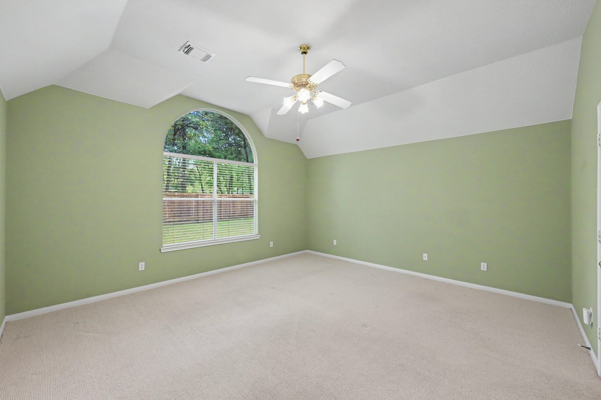 26 N Brooksedge Circle, The Woodlands, TX 77382 Spacious primary bedroom with vaulted ceiling and backyard views.