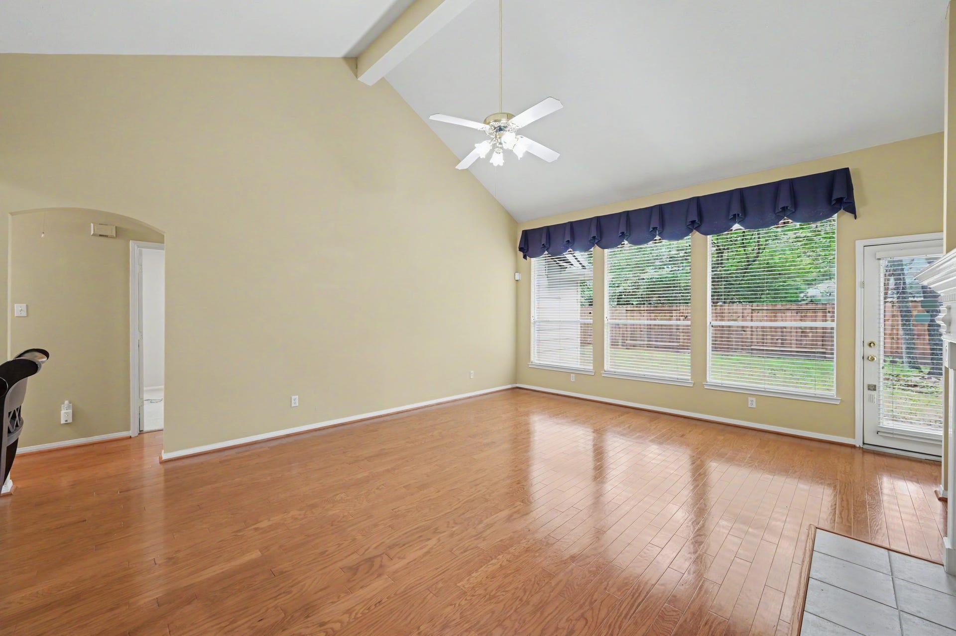 26 N Brooksedge Circle, The Woodlands, TX 77382 Main living space with vaulted ceiling, large windows, and back patio access.