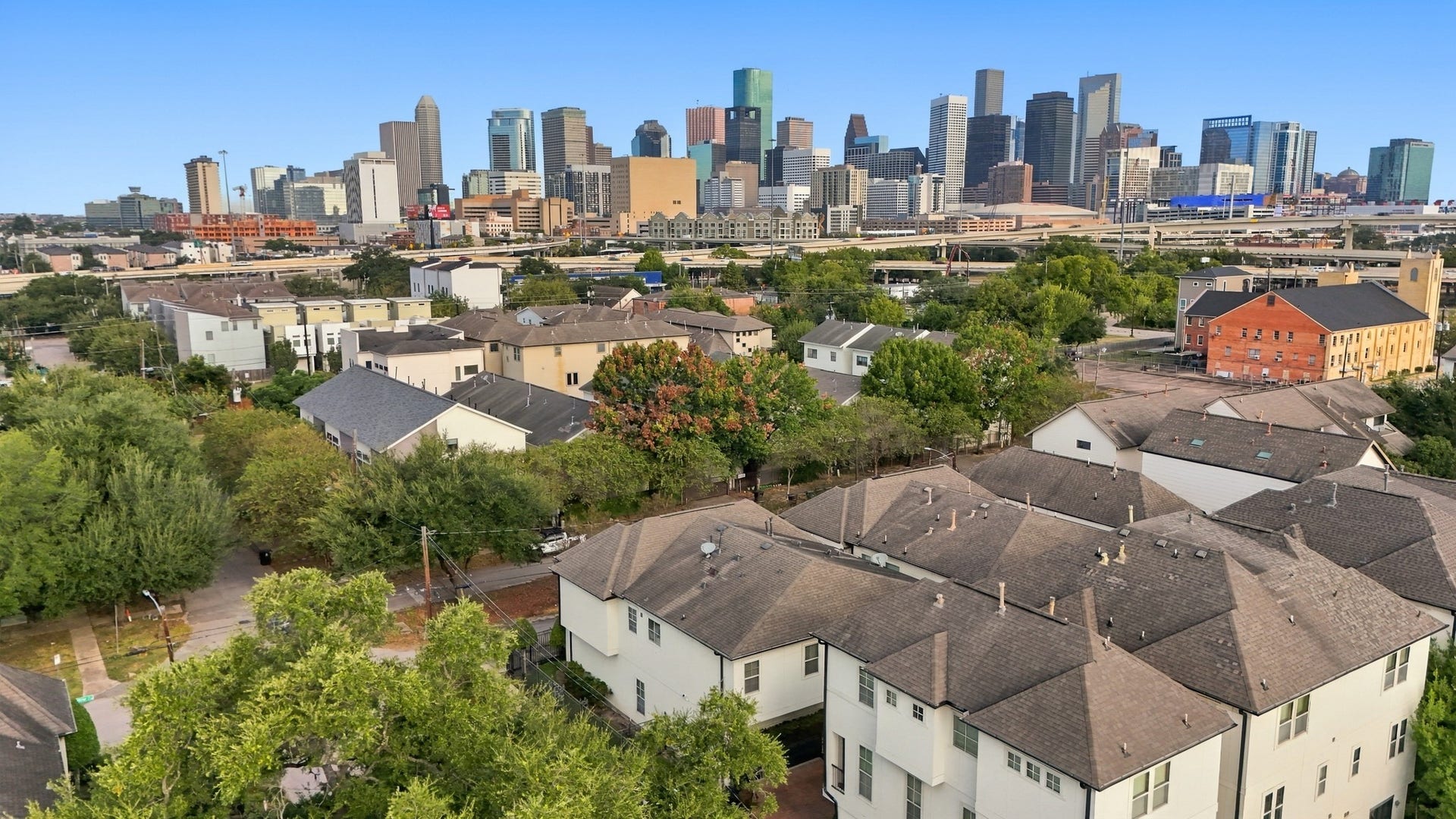 2217 Bastrop Street, Houston, TX 77003 Aerial view of townhome with skyline in the back.