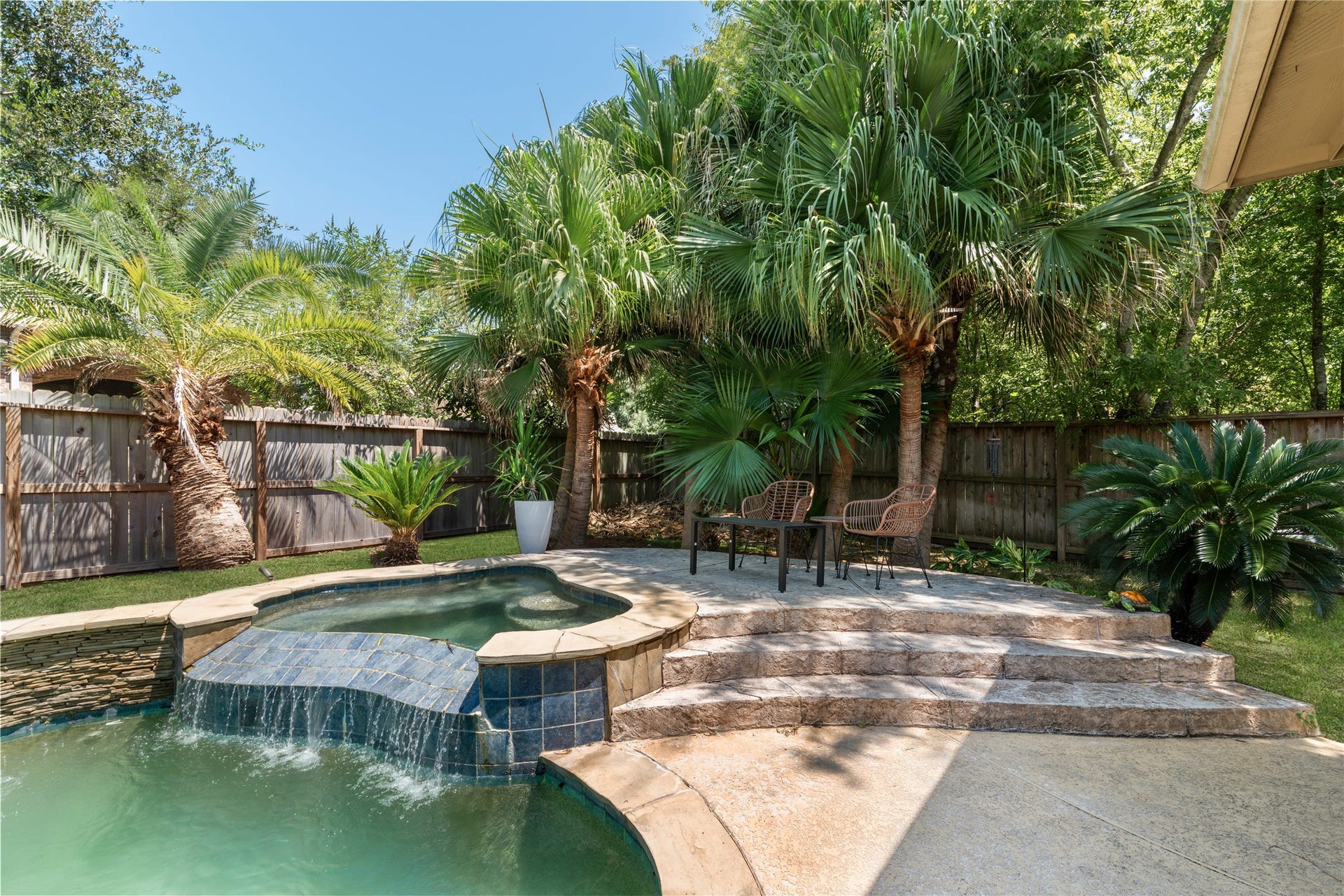 2525 W Ranch Drive, Friendswood, TX 77546 Tropical backyard oasis with pool and hot tub.