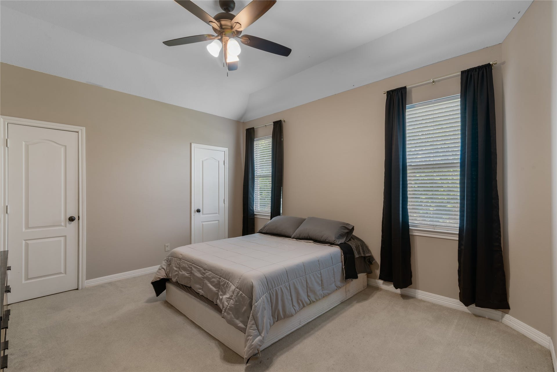 2525 W Ranch Drive, Friendswood, TX 77546 Another secondary bedroom upstairs featuring neutral tones, soft carpeting and large windows for natural light.