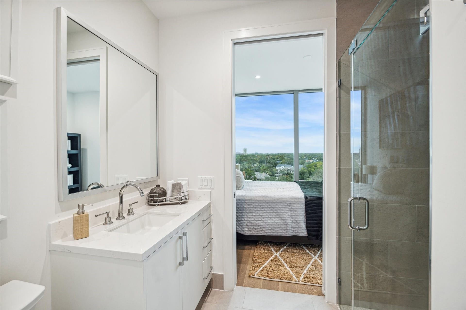 5656 San Felipe Street, #606, Houston, TX 77056 En-suite guest bathroom with glass in-framed walk-in shower. Photos are of a similar unit with the same floor plan