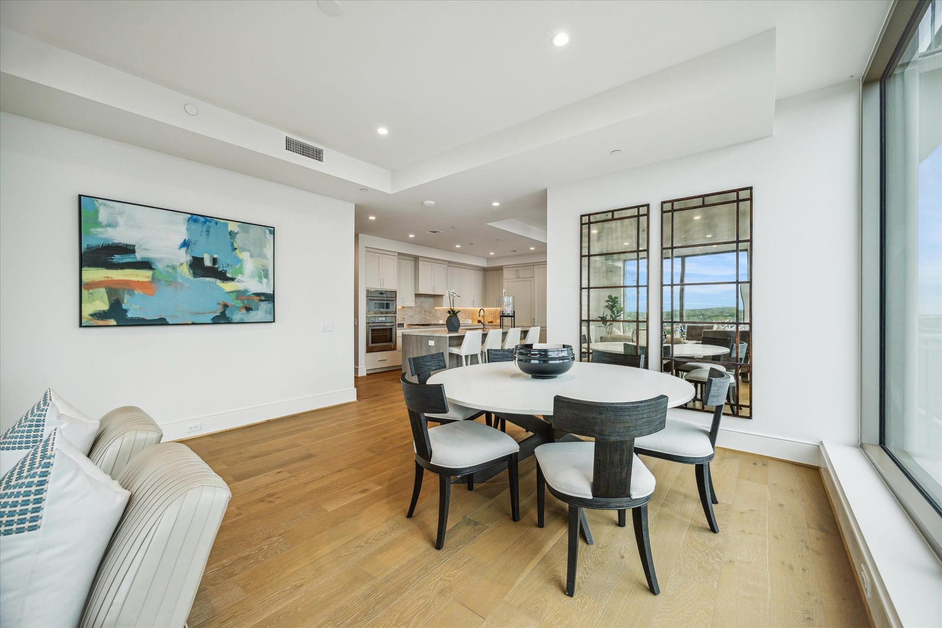 5656 San Felipe Street, #606, Houston, TX 77056 Spacious dining area features an open-concept layout seamlessly connected to the kitchen and living spaces. Photos are of a similar unit with the same floor plan