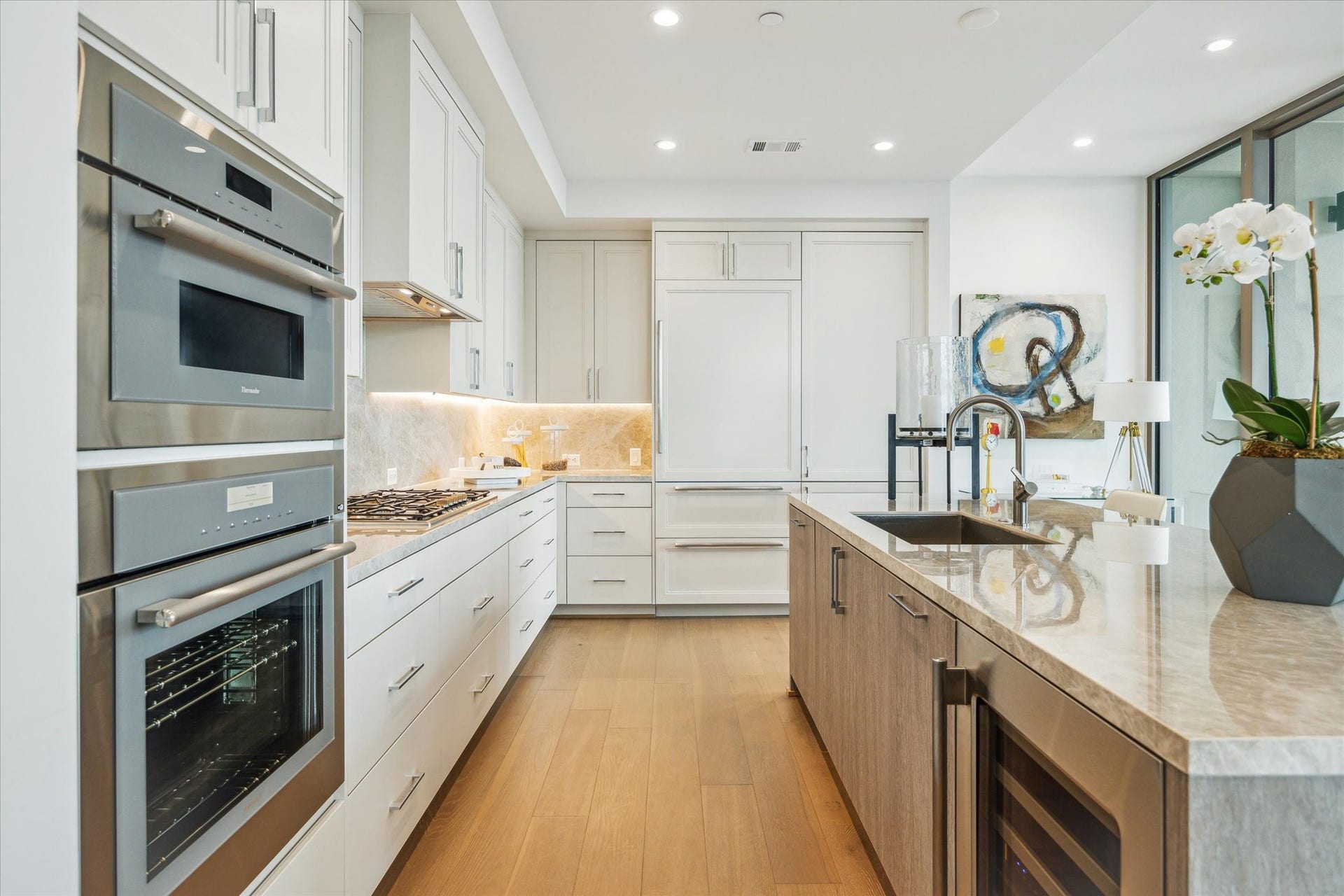 5656 San Felipe Street, #606, Houston, TX 77056 Spacious Kitchen featuring top-of line Thermador appliances, Wine Chiller and Sub-zero refrigerator with two freezer drawers. Photos are of a similar unit with the same floor plan