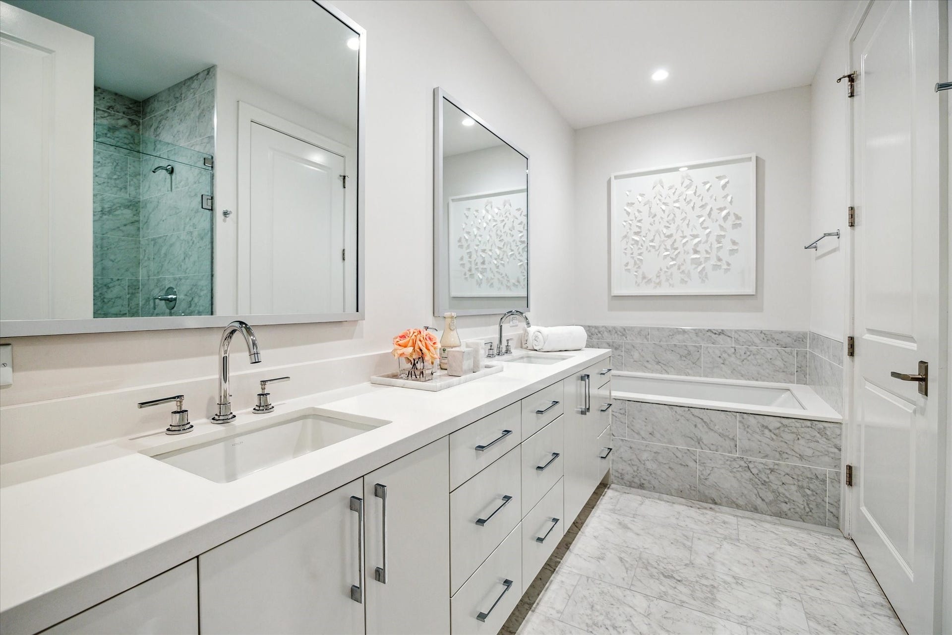 5656 San Felipe Street, #606, Houston, TX 77056 Primary bathroom with dual sinks, soaking tub, glass-framed walk-in shower with seat, private water closet, linen closet and a large walk-in dressing area. Photos are of a similar unit with the same floor plan