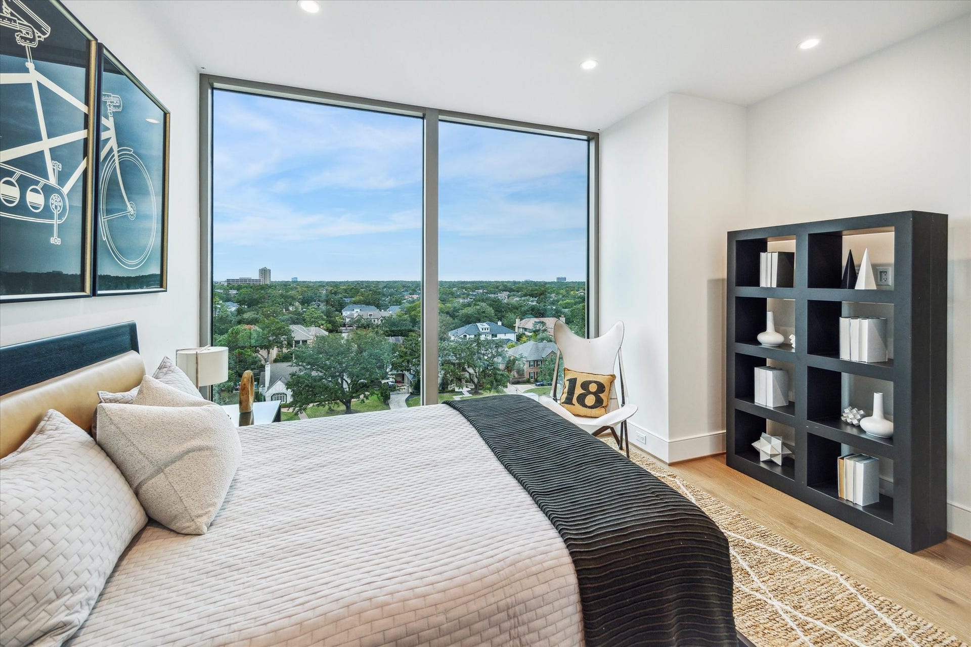 5656 San Felipe Street, #606, Houston, TX 77056 En-suite bedroom featuring floor-to-ceiling windows. Photos are of a similar unit with the same floor plan