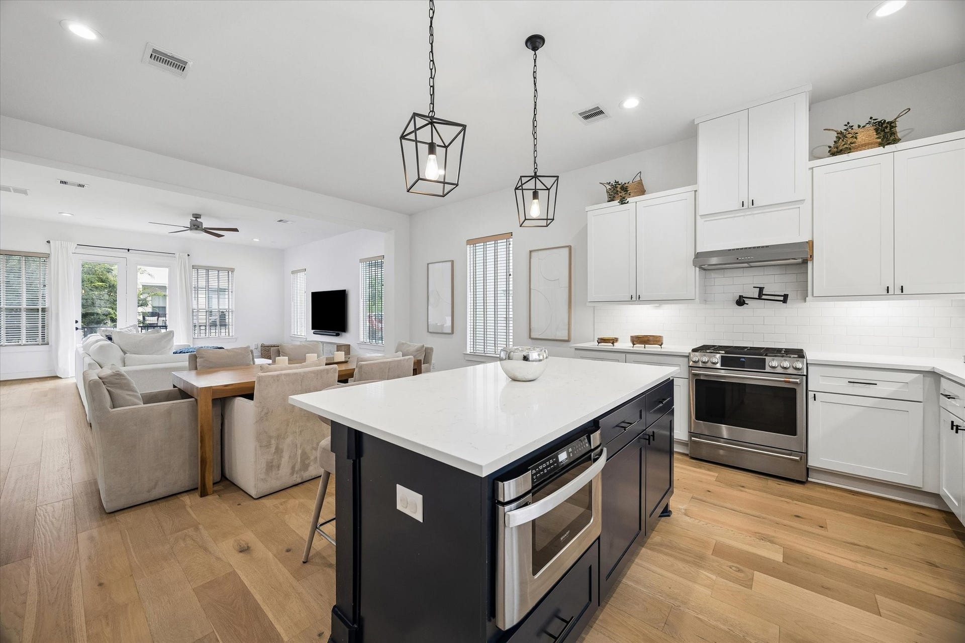 956 Dunleigh Meadows Lane, Houston, TX 77055 The chef-inspired island kitchen combines timeless style with modern functionality, featuring quartz countertops and stainless-steel appliances.
