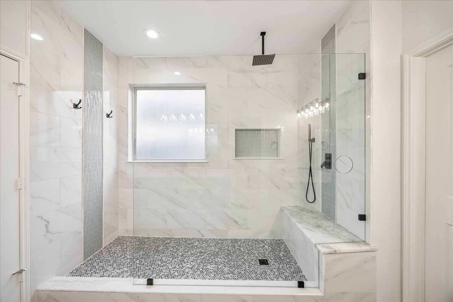 30 Glade Park Drive, Missouri City, TX 77459 Enjoy a daily dose of luxury in this oversized walk-in shower. With a rainfall showerhead, body spray, beautiful designer tile, and frameless glass enclosure, it's the perfect place to wash away a busy day or get a refreshing start to the next one.