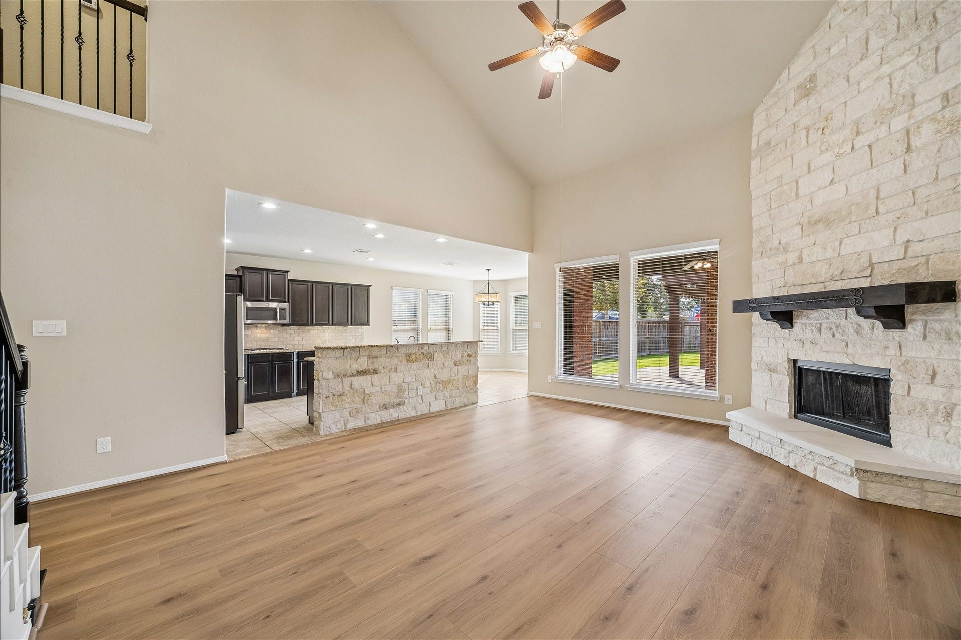 30 Glade Park Drive, Missouri City, TX 77459 There's plenty of room to gather, relax, and enjoy the comforts of home in this spacious family room. A soaring vaulted ceiling, updated wood-look laminate flooring, and a beautiful stone gas log fireplace make this a welcoming spot for everyday living and entertaining.