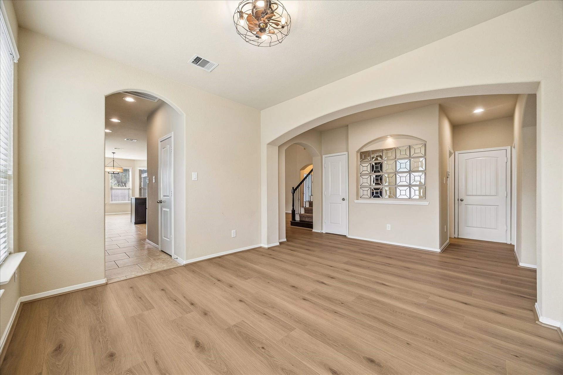 30 Glade Park Drive, Missouri City, TX 77459 You may be inspired to entertain a little more often in this beautiful formal dining room! Updated wood-look laminate flooring, stylish lighting, and arched openings create a welcoming space for everything from holiday feasts to Wednesday night lasagna.