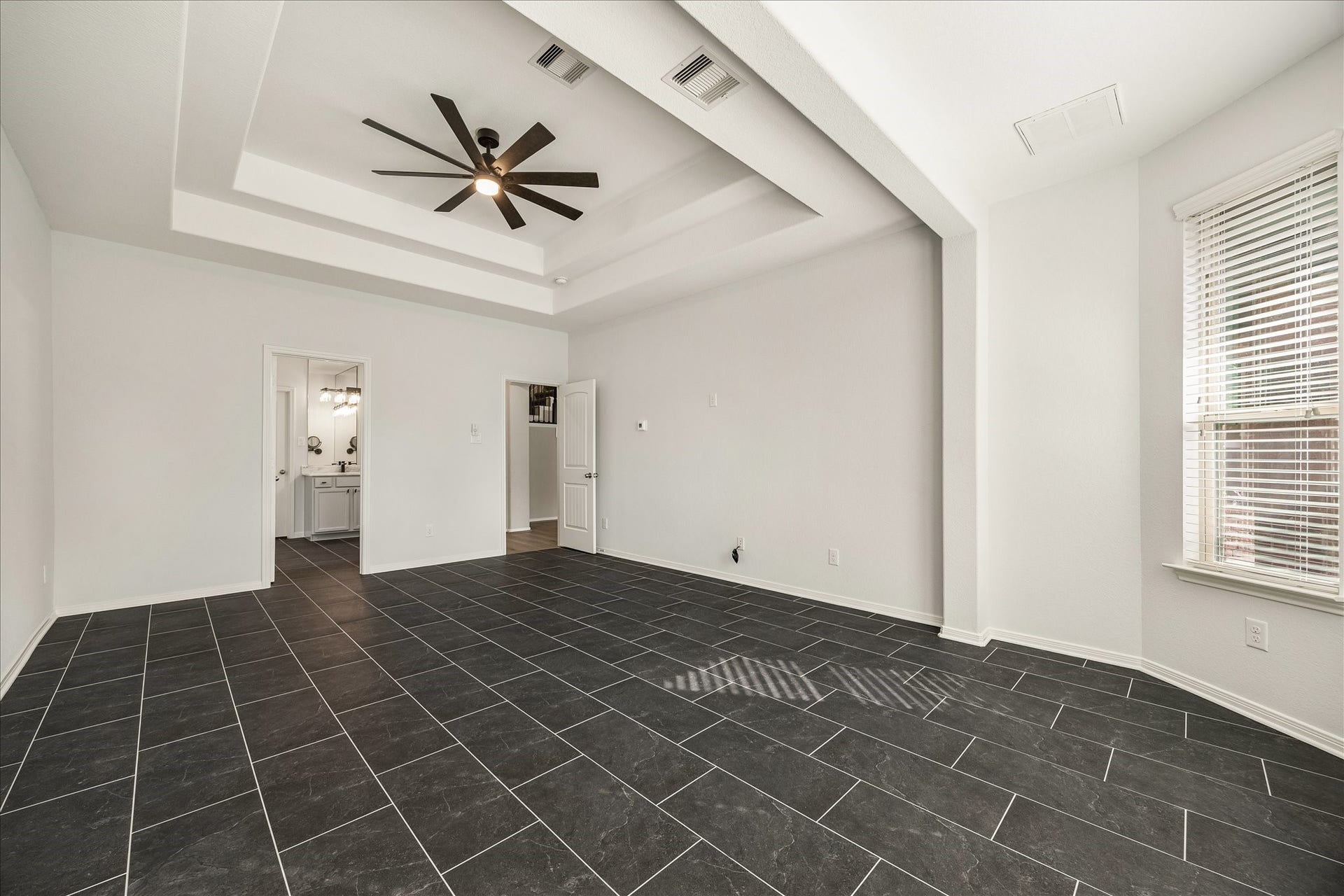 30 Glade Park Drive, Missouri City, TX 77459 Your own private getaway awaits in this spacious primary suite. A beautiful tray ceiling with a cooling fan adds character overhead, while a spa-like ensuite bathroom and massive walk-in closet make getting ready for the day a little more enjoyable.
