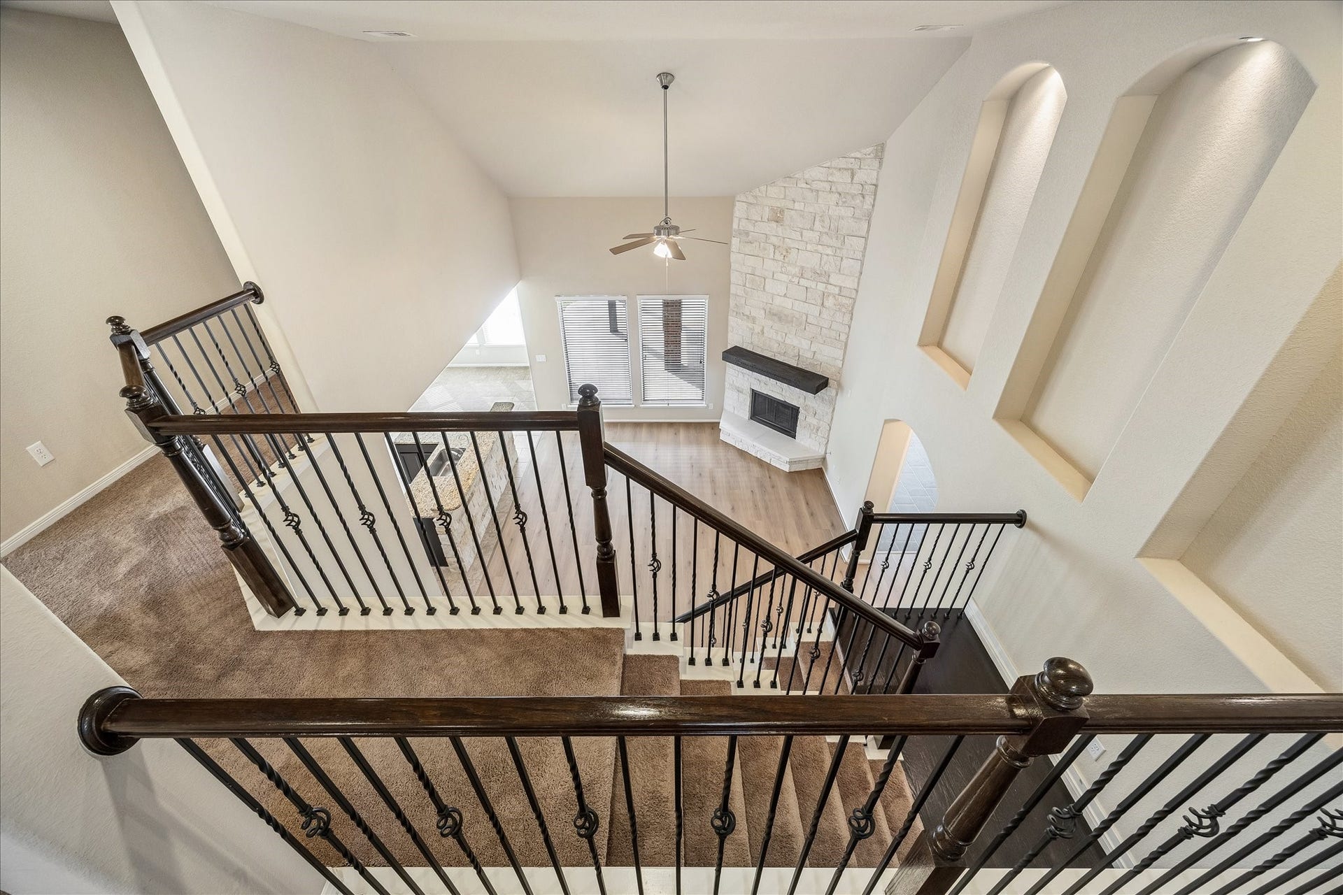 30 Glade Park Drive, Missouri City, TX 77459 Take a moment to enjoy the view from above. A towering ceiling, lit art niches, and handsome iron balusters with wood railings add architectural charm, while the stunning floor to ceiling stone fireplace makes an impressive statement below.