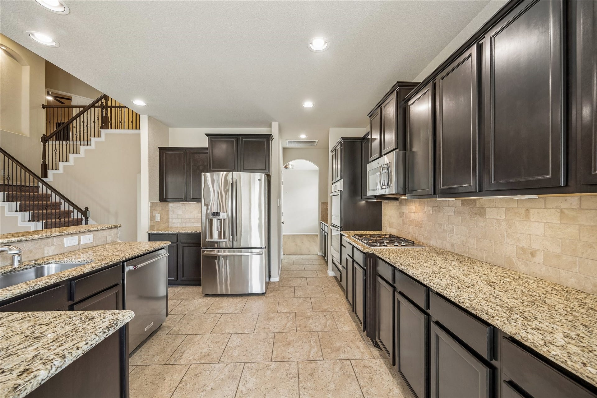 30 Glade Park Drive, Missouri City, TX 77459 Cooking is a little more enjoyable when you have the right tools. This well-equipped kitchen offers stainless-steel appliances, including double electric ovens, a gas cooktop, microwave, and dishwasher. Granite countertops, tile backsplash, and under-cabinet lighting complete the space and brighten your workspace.
