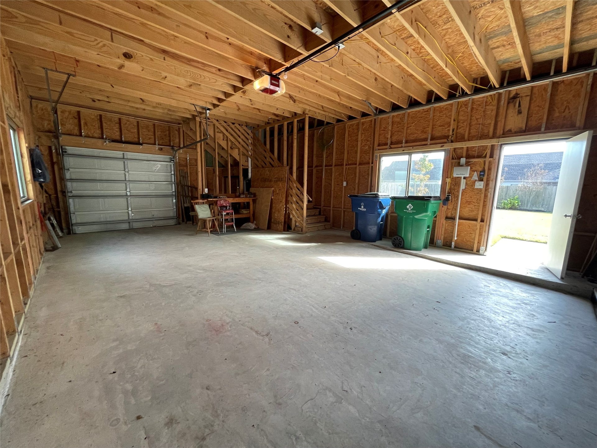 6535 Bastrop Trail, Manvel, TX 77578 Interior of the garage with stairs to the game room
