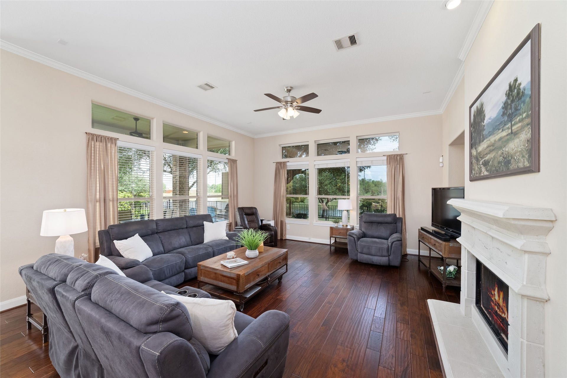 9234 E Canyon Lake Springs Drive, Cypress, TX 77433 You won't feel crowded here! Check out the space of this room with crown molding, fireplace and plenty of windows to bring in natural light and showcase the water view.