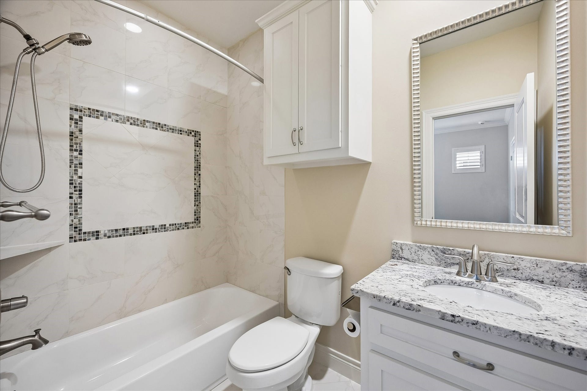 Secondary full bath. This home also offers two powder rooms