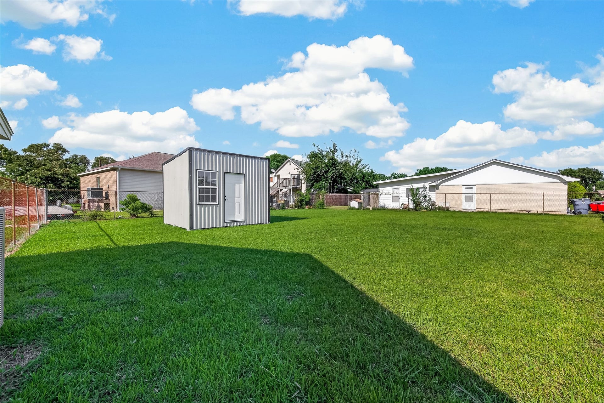 7502 Nightingale Circle, Texas City, TX 77591 Well-built detached storage shed offering excellent additional space for tools, lawn equipment, seasonal items, workshop, or she-shed. Features durable metal siding, a single-entry door, and a large window that provides abundant natural light. A practical and versatile addition to the property.
