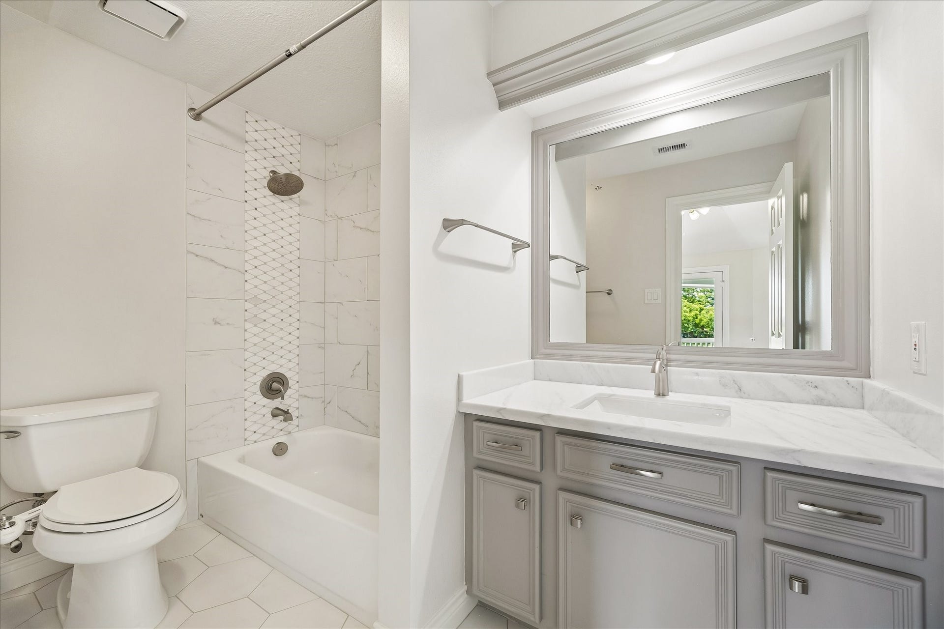 3319 Oakland Drive, Sugar Land, TX 77479 Fully remodeled guest room en-suite bathroom showcasing Dolomite marble countertop.