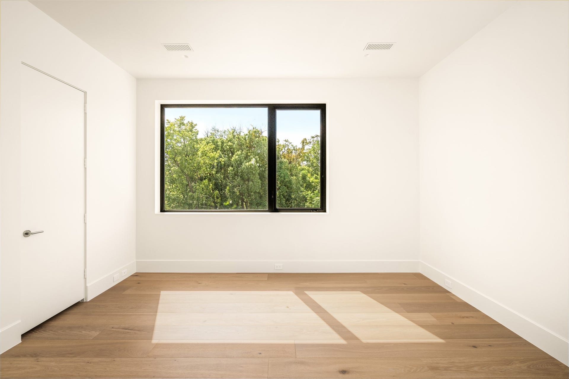 11 Tiel Way, Houston, TX 77019 This comfortable bedroom suite offers a versatile layout, a generous closet, and serene treetop views through a a large picture window.
