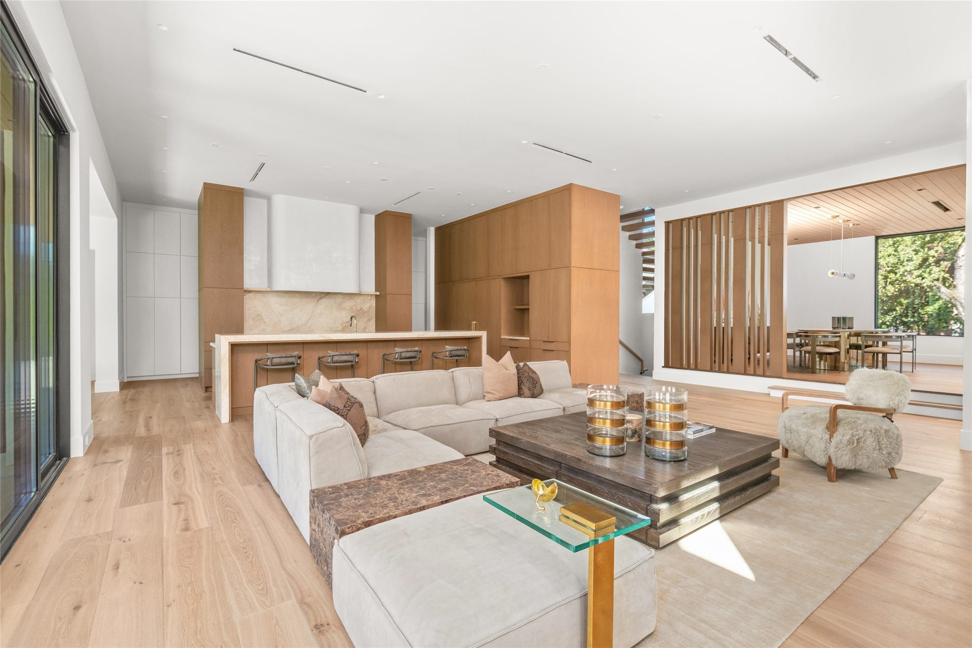 11 Tiel Way, Houston, TX 77019 This perspective brings the family room, chefs kitchen, and elevated dining room together, showcasing the thoughtful arrangement of the home's main living spaces and the ease with which they flow from one to the next.