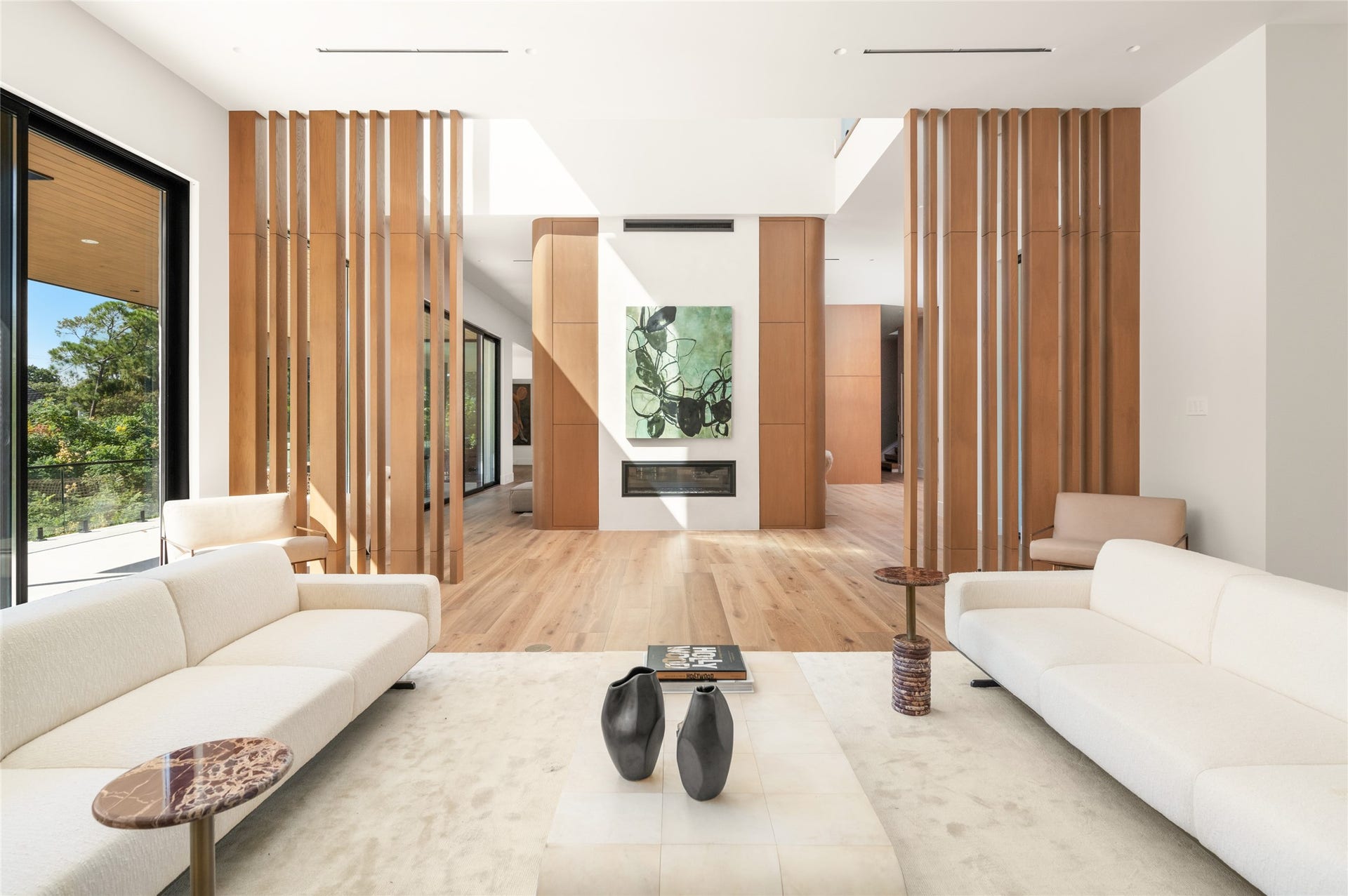 11 Tiel Way, Houston, TX 77019 Back inside, the bar area sits just off the extended terrace and opposite the family room fireplace, with sculptural wood partitions, warm natural finishes and an open layout that connects the surrounding living spaces.