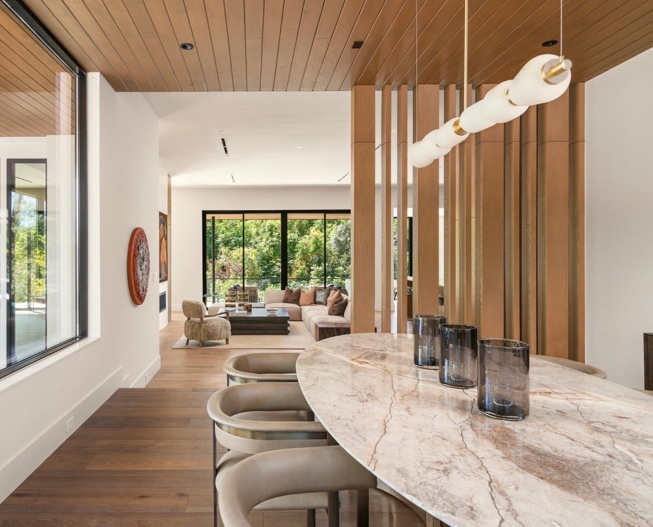 11 Tiel Way, Houston, TX 77019 From the dining room, the home's thoughtful design comes into focus, with warm wood ceilings, beautiful architectural glass, and views extending toward the adjoining family room and entertaining bar.