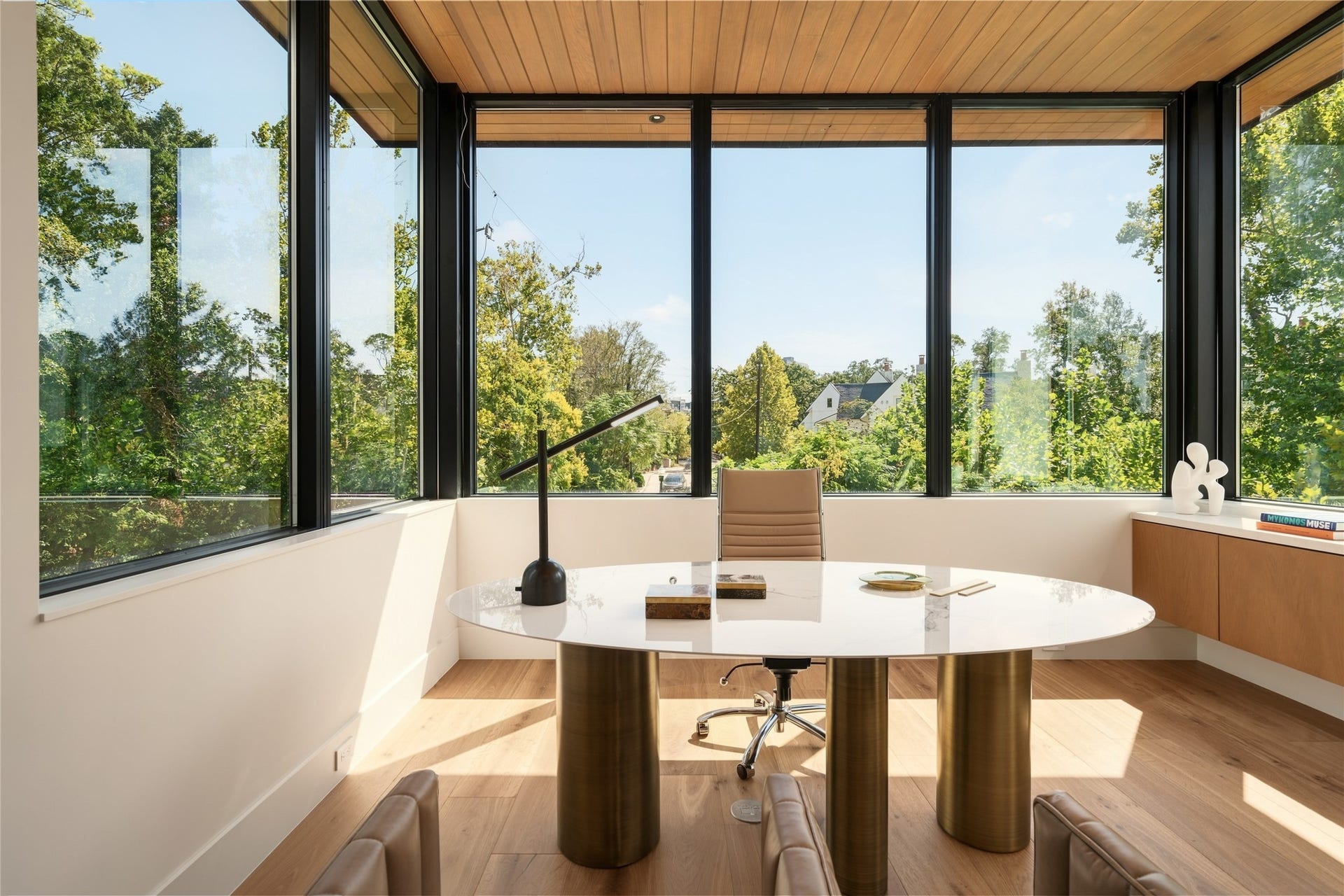 11 Tiel Way, Houston, TX 77019 Privately positioned at the far end of the main level, the dedicated study offers a quiet retreat from the home's entertaining spaces, with walls of glass on three sides, custom cabinetry, and sweeping views that make working from home a pleasure.