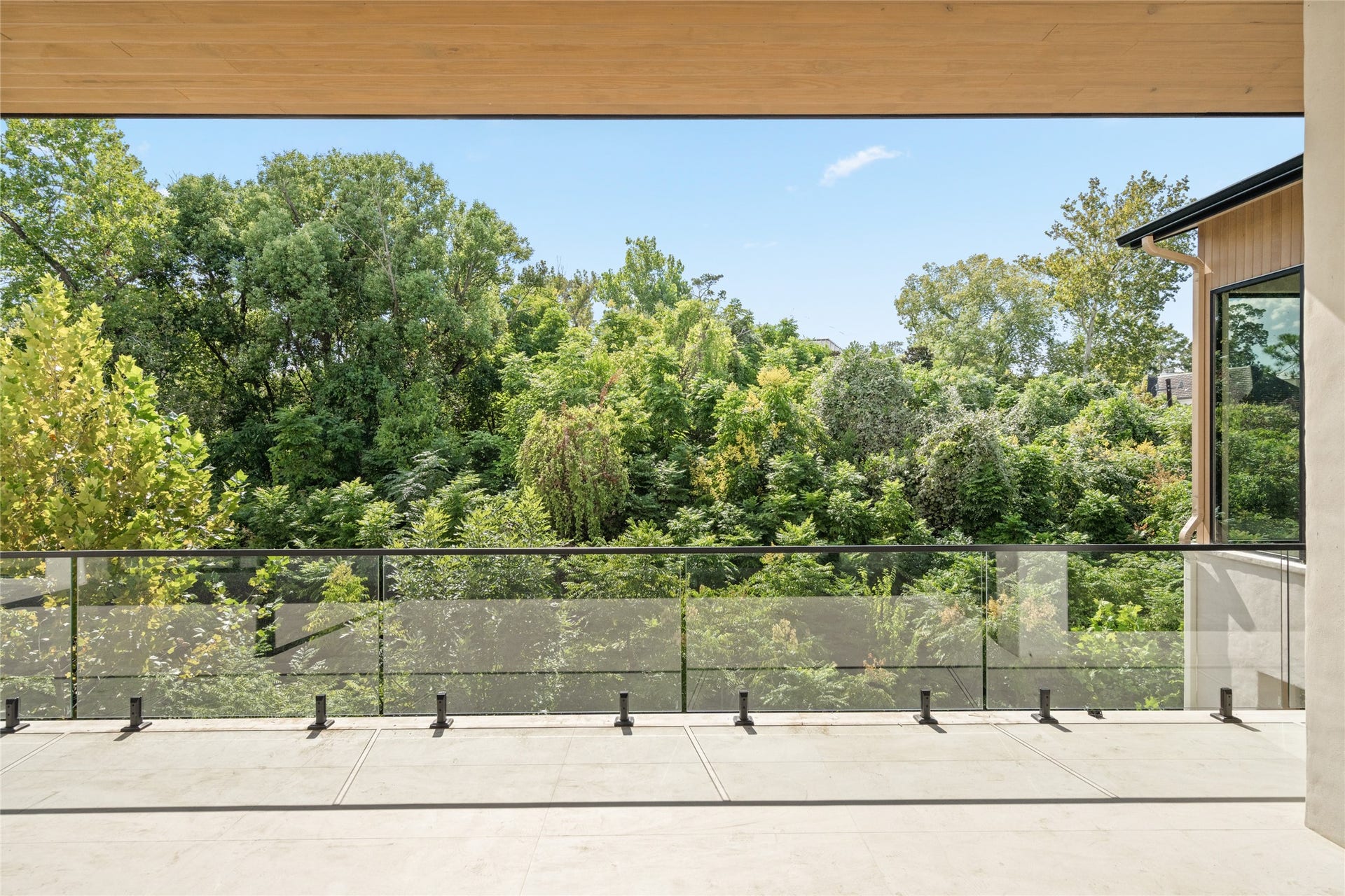 11 Tiel Way, Houston, TX 77019 A beautiful canopy of trees creates a peaceful backdrop for the expansive main-level terrace, offering a sense of privacy and a wonderful place to enjoy the outdoors.