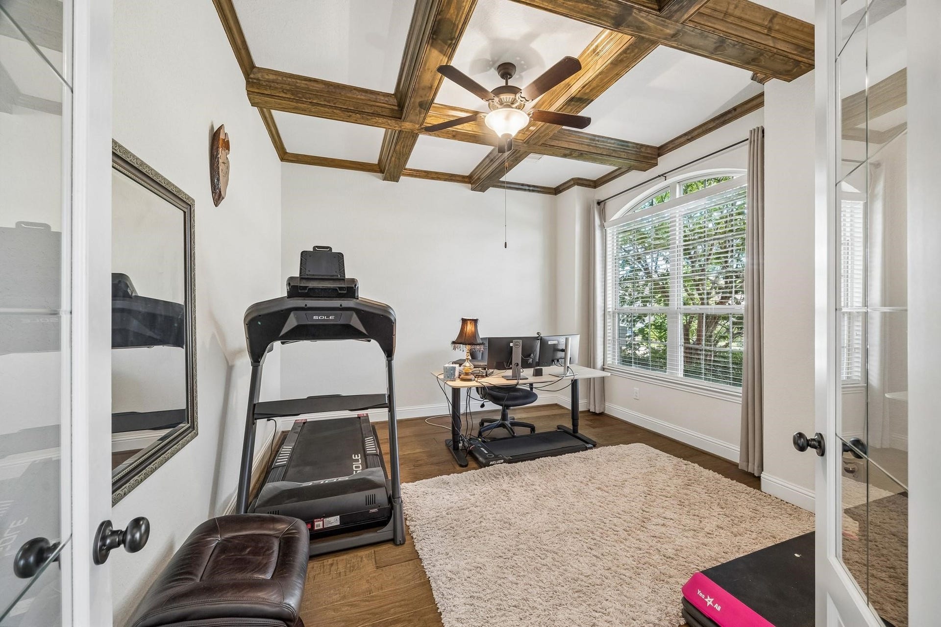 6031 Granite Shadow Lane, Porter, TX 77365 Office with striking coffered wood ceiling, rich hardwood flooring, oversized arched window, elegant french doors.