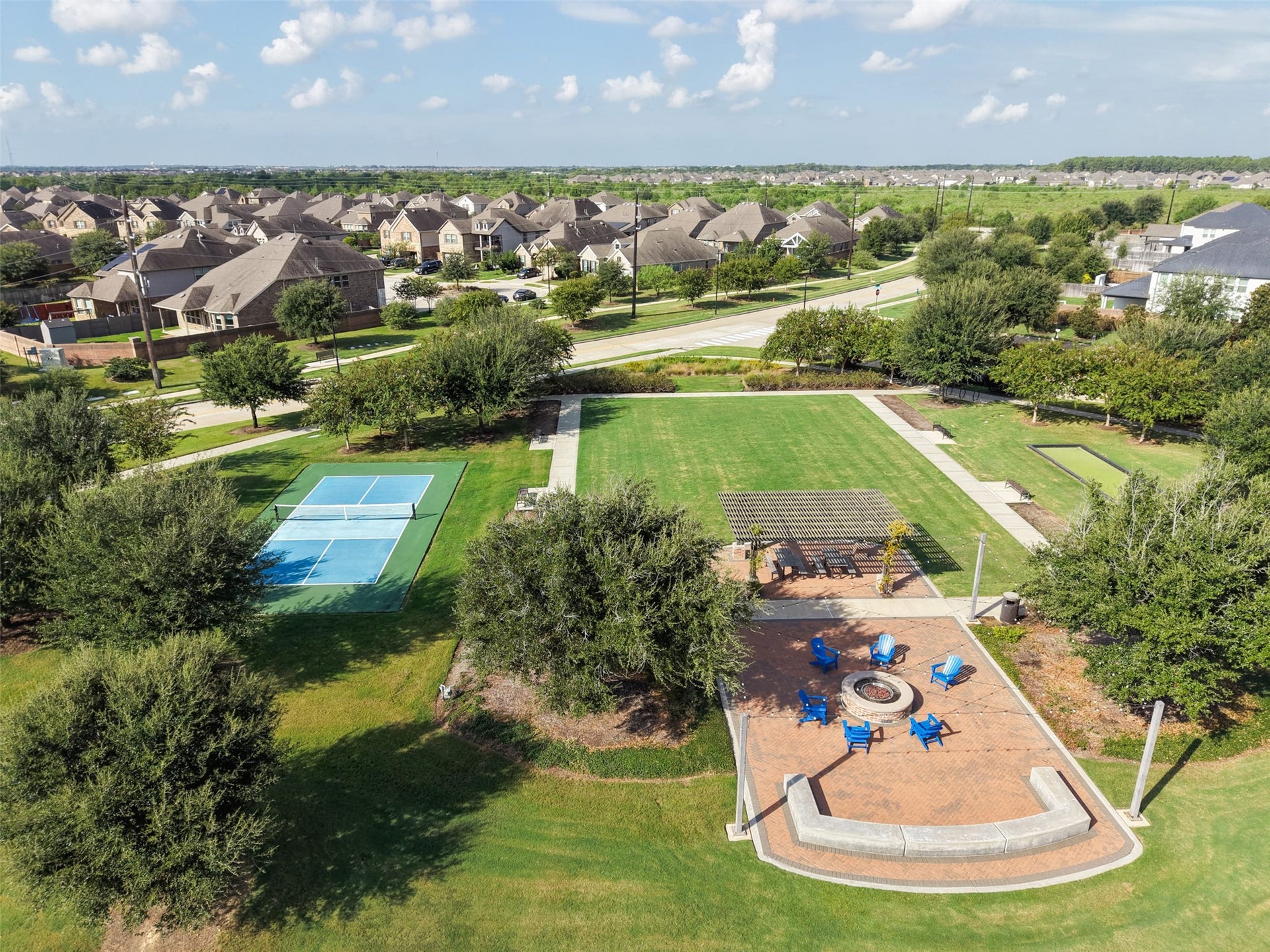 23926 Arcola Glen Lane, Katy, TX 77493 Lawn space for kids to run and play, tennis courts, and a firepit are a few of the great amenities in the Elyson master planned community.